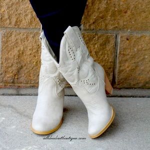Very volatile white cowboy boots